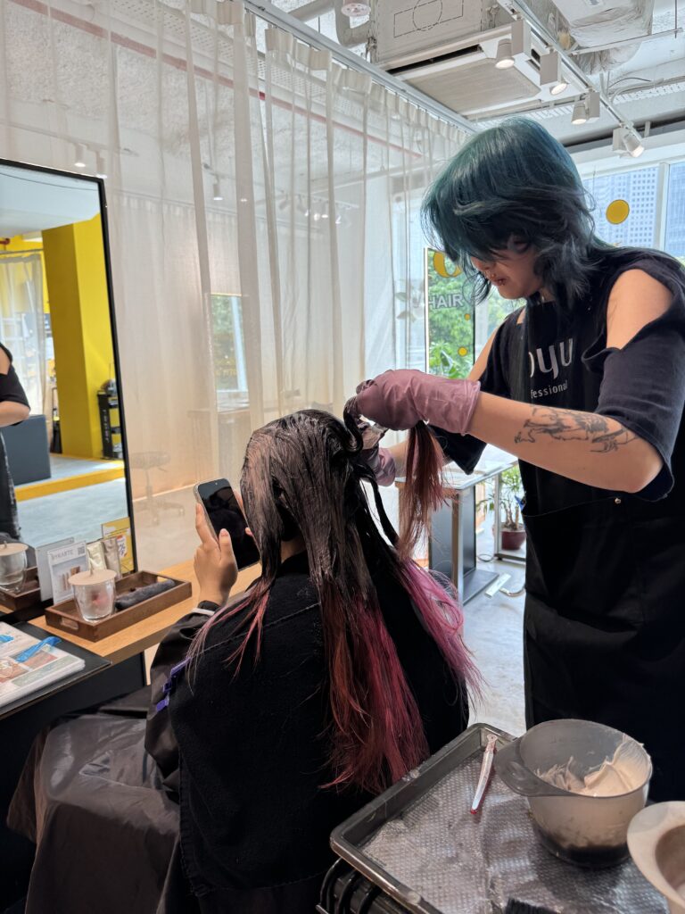 Hands-on color training session at Colors Japanese Hair Salon Singapore with stylists supervising ITE intern in real salon practice near Clarke Quay, Chinatown, and Havelock Road.