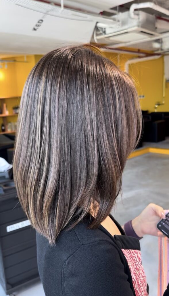 Natural fine highlights with ash brown base color at Colors Japanese Hair Salon Singapore, low layer medium cut with soft grey blending