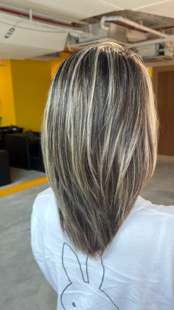 Grey blending highlights on medium-length hair in Singapore, seamless white hair blending with fine highlights, smooth regrowth, glossy cool-toned finish at a Japanese hair salon near Clarke Quay MRT.