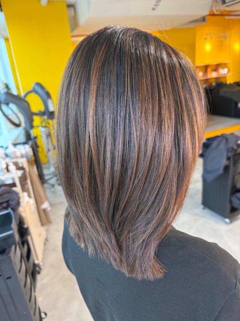 Natural brown highlights with soft layered haircut at Colors Japanese Hair Salon Singapore near Clarke Quay and Chinatown creating natural dimension and movement