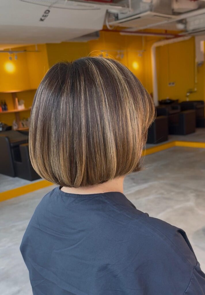 Grey blending beige highlights with precision bob haircut at Colors Japanese Hair Salon Singapore near Clarke Quay and Chinatown creating soft dimension and natural white hair blending