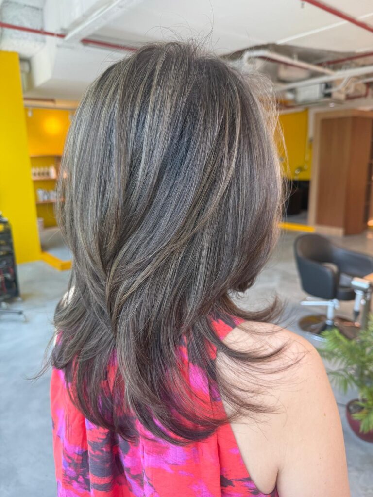 Grey Blending Highlights Layered Haircut Singapore | Japanese Hair Salon Singapore 1 Grey blending highlights layered haircut Singapore by Colors Japanese Hair Salon Singapore near Clarke Quay MRT, natural white hair blending with soft volume and low-maintenance color