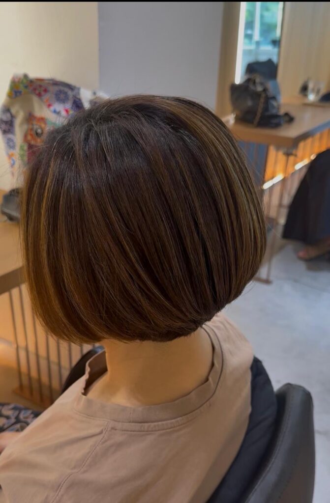 Natural highlight bob haircut with soft dimension at Colors Japanese Hair Salon Singapore near Clarke Quay and Chinatown creating a clean neckline and balanced silhouette