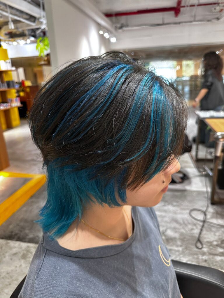 Short wolf haircut with blue green highlights on black hair base at Colors Japanese Hair Salon Singapore, bleach design suitable for men and women