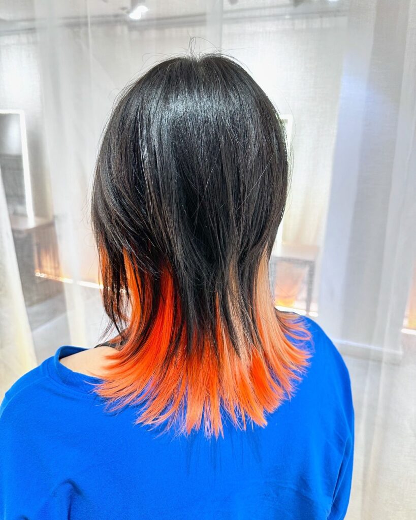 Orange and yellow inner bleach design at Colors Japanese Hair Salon Singapore, Japanese hair salon near Clarke Quay, low-damage PLEX bleach with soft wolf cut and natural base