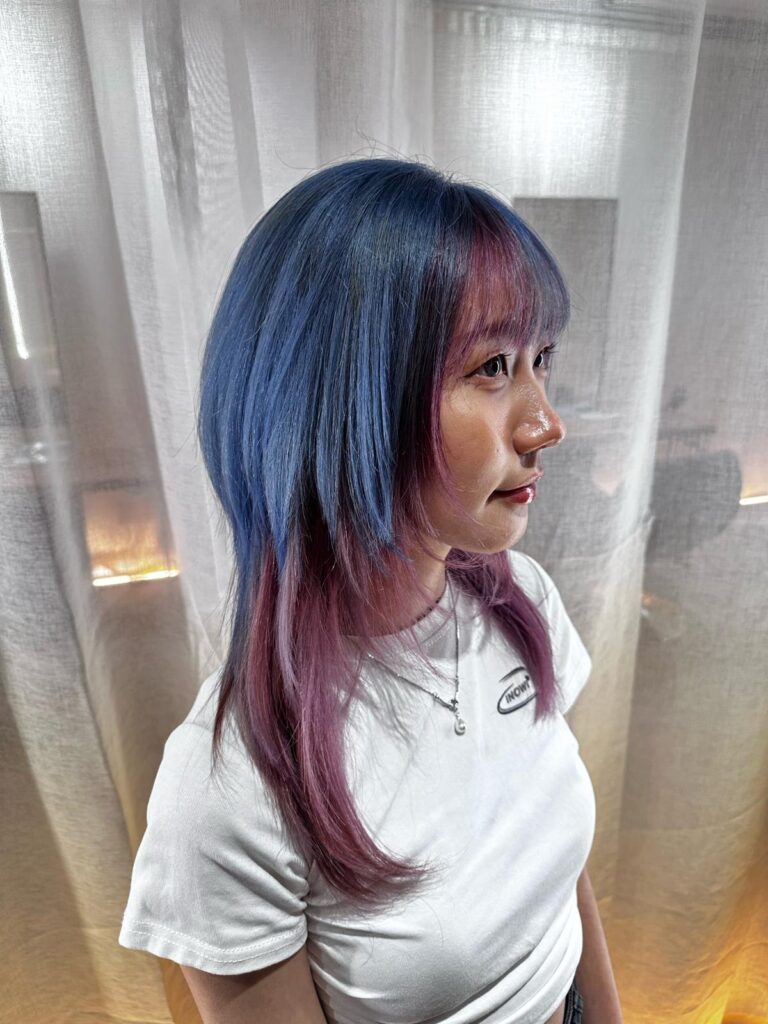 Full bleach design color with pink, black and ash blue on wolf cut with bangs at Japanese hair salon Singapore