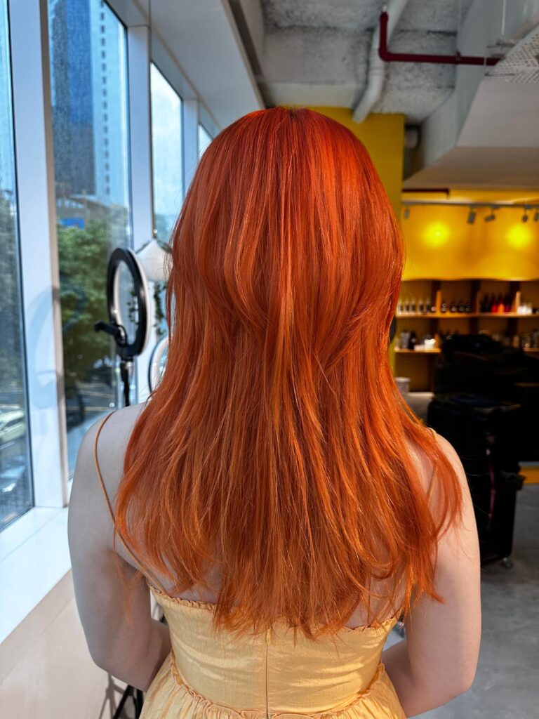 Long layered hair with single bleach bright orange color using plex formula at Japanese Hair Salon Singapore near Clarke Quay and Chinatown