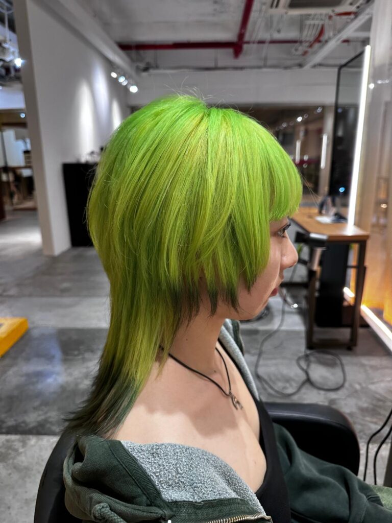 High layer jellyfish haircut with double bleach lime green color and black contrast ends at Japanese Hair Salon Singapore near Clarke Quay