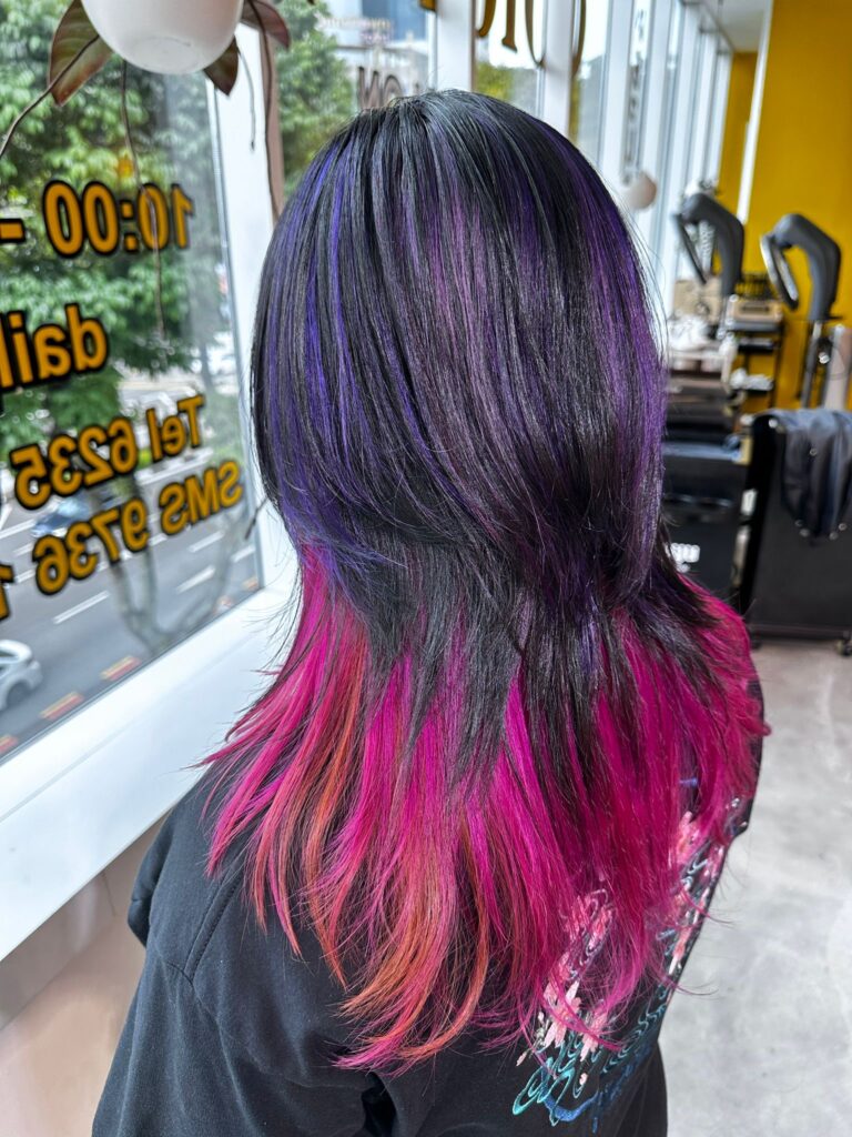 Purple and black outer hair with orange and pink inner color design at Japanese Hair Salon Singapore Singapore