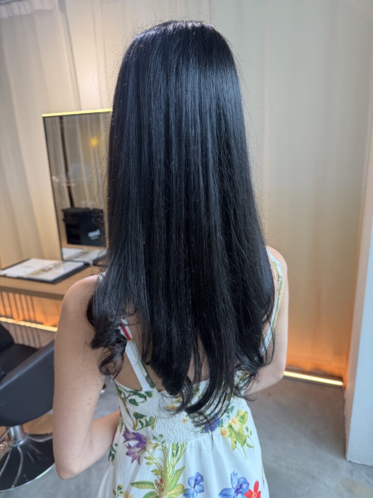 Blue black long hair color on naturally brown hair with sleek long haircut at Japanese Hair Salon Singapore