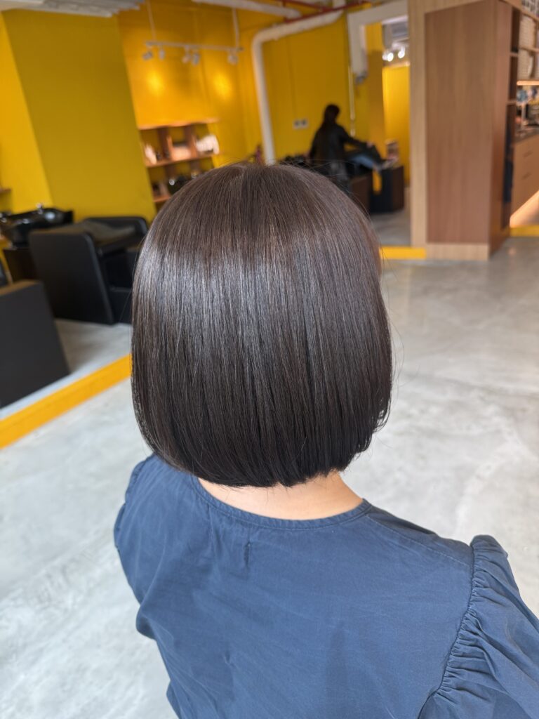 White hair coverage brown hair color with bob haircut at Colors Japanese Hair Salon Singapore near Clarke Quay creating natural grey coverage and elegant bob hairstyle
