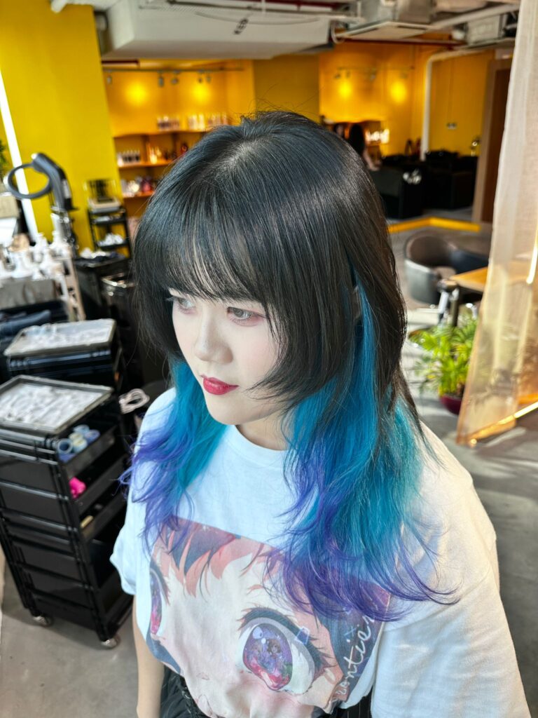 Blue and purple inner color gradient on layered medium hair at Japanese Hair Salon Singapore