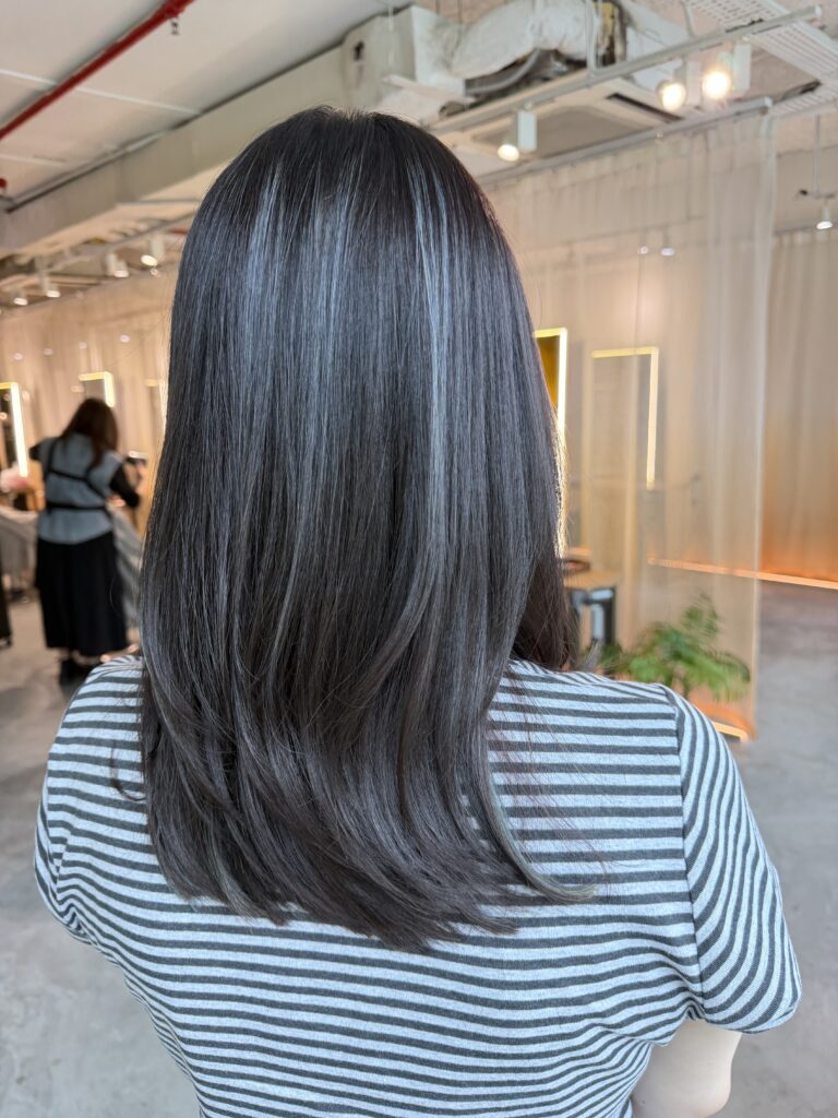 Dark Ash Hair Color for long hair by Colorist Ura at Colors Japanese Hair Salon Singapore, creating healthy shine, cool tones, and a low-damage glossy finish.