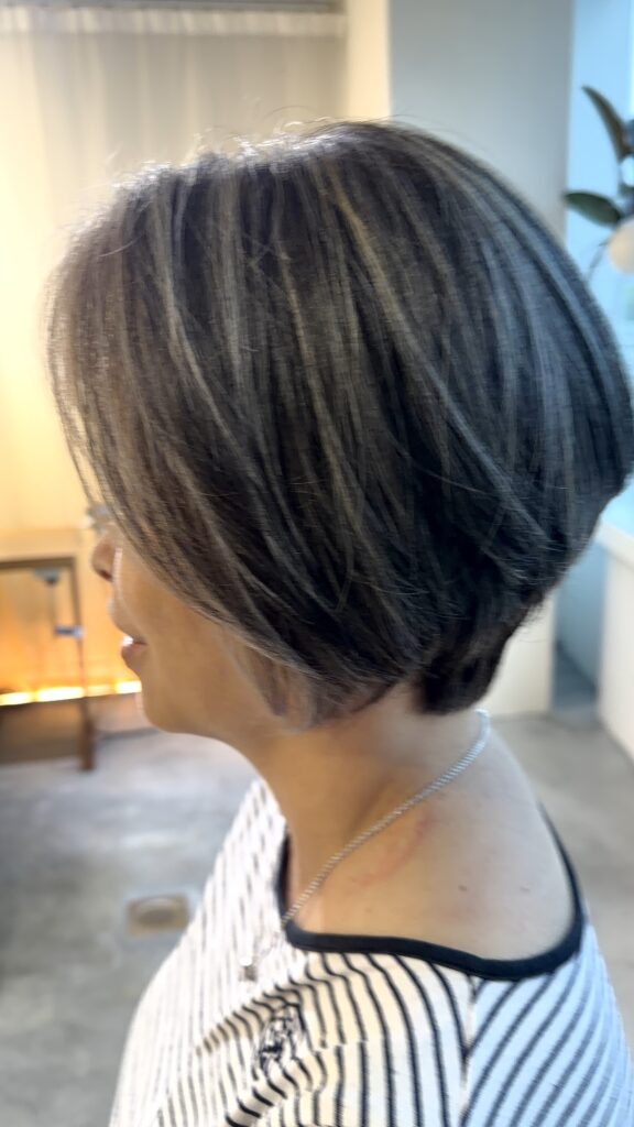 Singapore Grey Blending Highlights with cool silver grey tones and a clean short bob, blending natural grey hair without full coverage by Stylist Carmen and Colorist Ura.