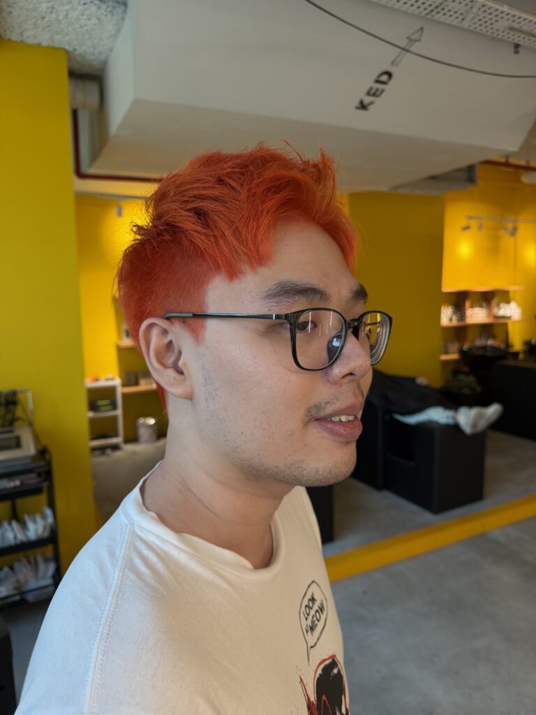 Men’s Bright Orange Bleach Short Hair Singapore | Japanese Hair Salon Singapore 1 Men's orange bleach hair color by Stylist Faye and Colorist Ura at Colors Japanese Hair Salon Singapore, featuring a vibrant first-time fashion color transformation.
