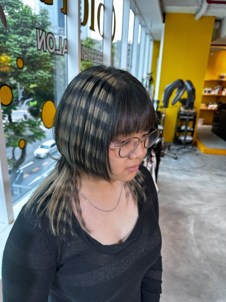 Bangs with Hime Cut and Layered Hair featuring Bleach Design Stripe Color at Japanese Hair Salon Singapore. Face-framing haircut with removable black stripe pattern and creative bleach color.