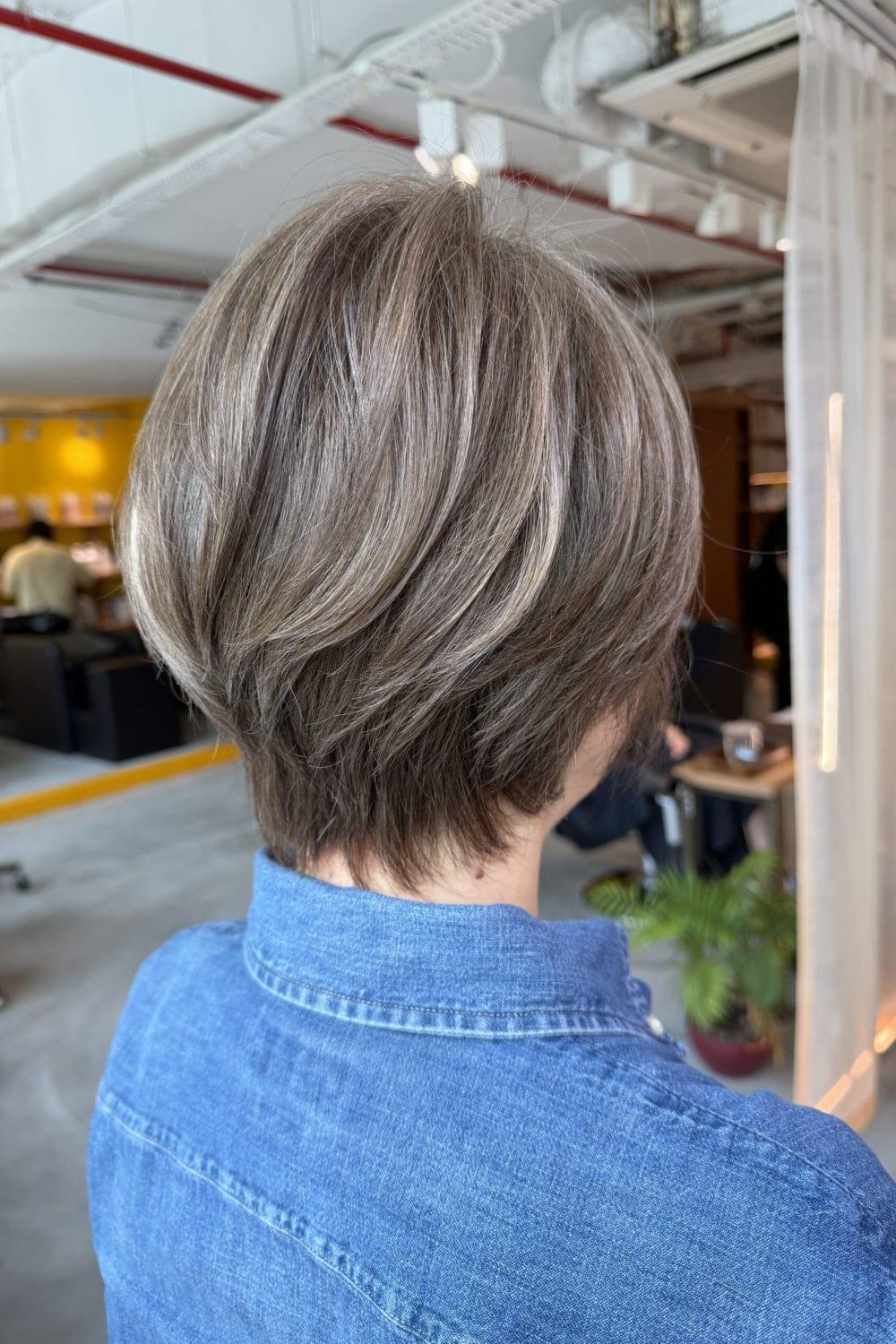 Grey blending short hair with low damage bleach highlights at Colors Japanese Hair Salon Singapore near Clarke Quay. Natural silver highlights blended with dark base color for soft grey coverage and easy maintenance short hairstyle.