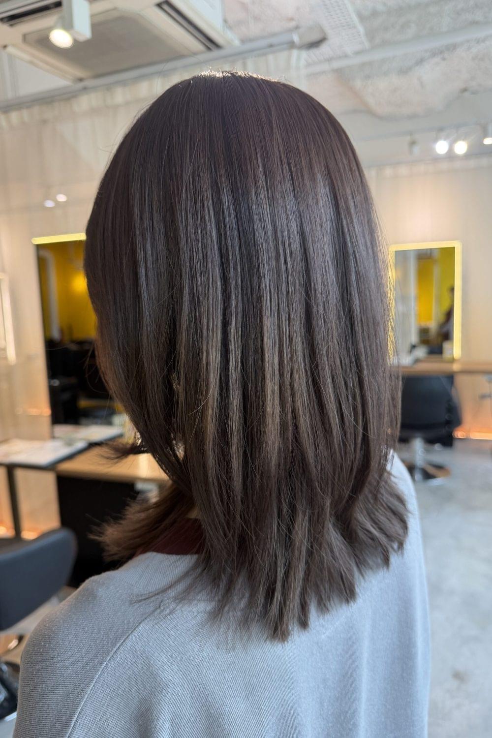 Dark ash layered medium hair with low-damage plex color at Japanese hair salon Singapore, bleach correction color, soft movement layer cut, glossy ash brown hair near Clarke Quay