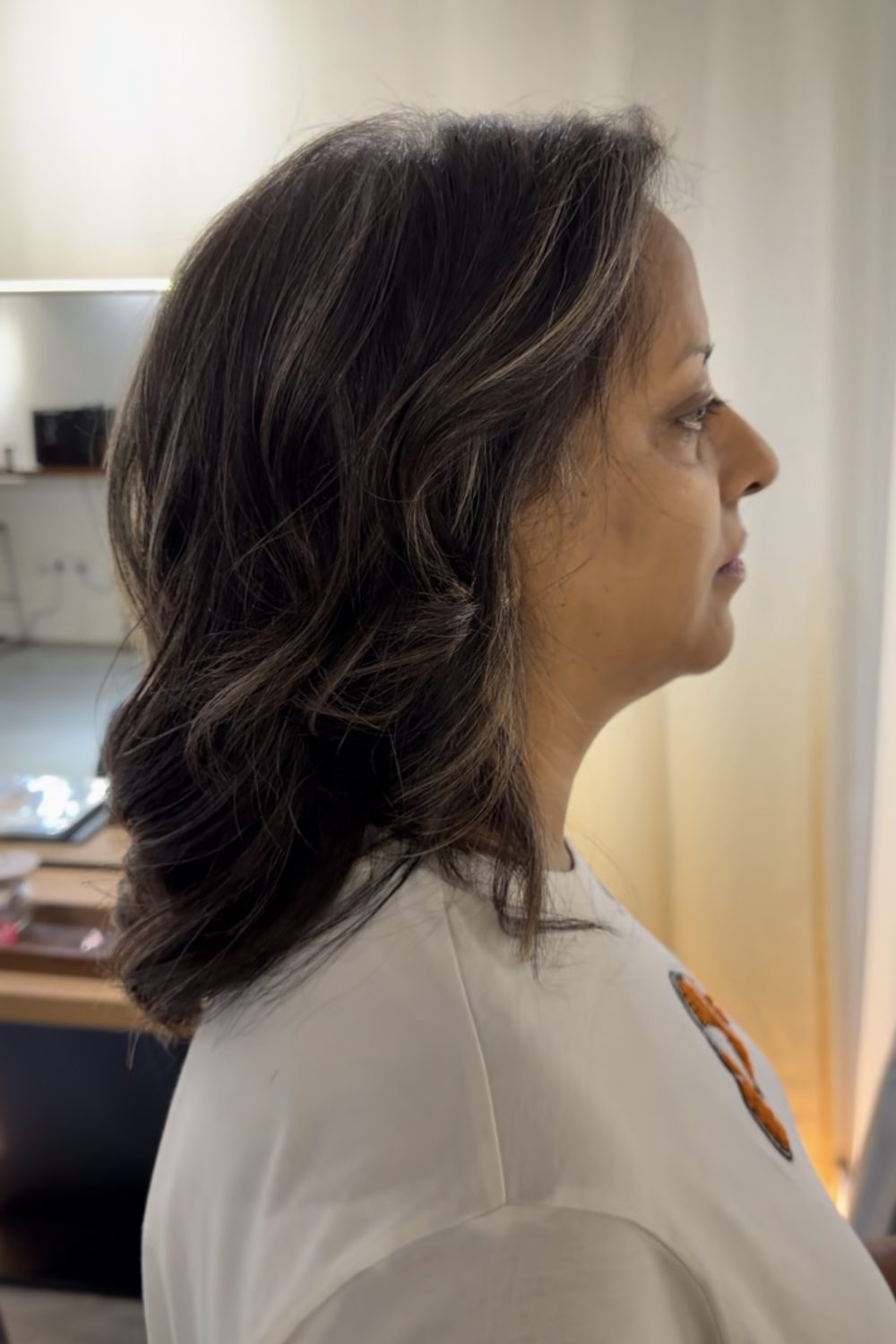 Grey blending medium hairstyle with natural grey hair, fine bleach highlights, and cool silver tones at a Japanese Hair Salon Singapore. A low-maintenance grey blending color finished with BYKARTE home care for healthy, shiny hair.