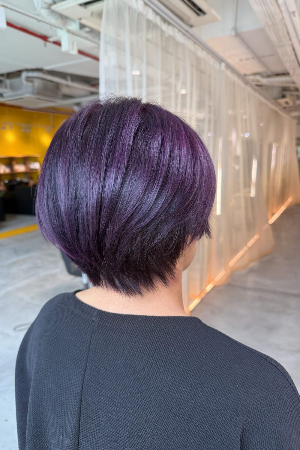 Deep purple short graduated haircut created with full bleach retouch and Plex technology at a Japanese Hair Salon Singapore for vibrant long-lasting fashion hair color.