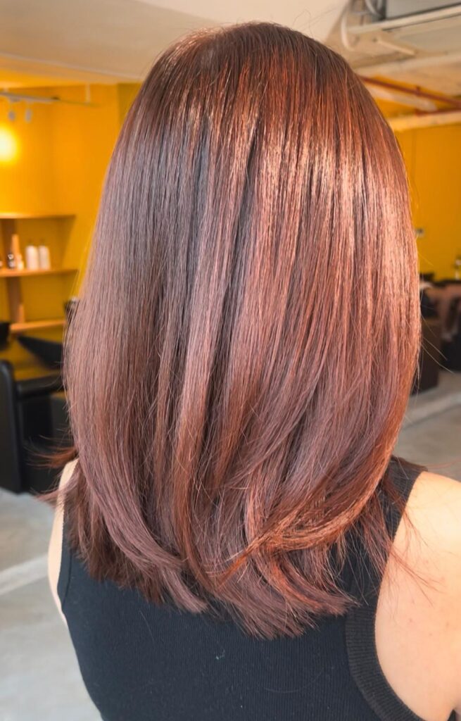 Light copper brown hair color without bleach with long layered haircut at Japanese Hair Salon Singapore near Clarke Quay Chinatown for natural shine and movement