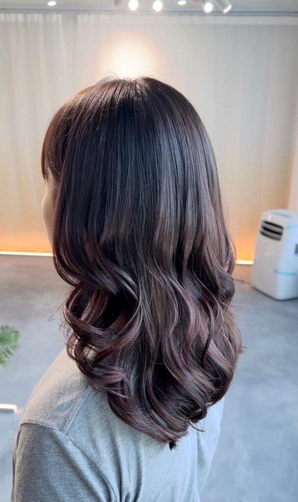 Digital perm medium layered hairstyle with warm brown hair color at Japanese Hair Salon Singapore, humidity-resistant long-lasting curls