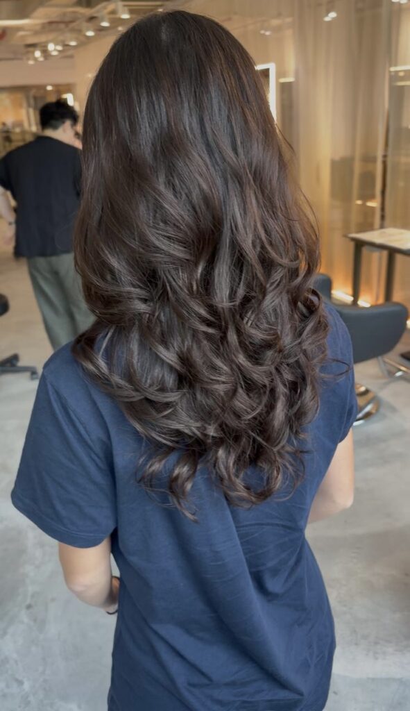 Long digital perm with soft curls and natural movement by Senior Stylist Sylvia at Colors Japanese Hair Salon Singapore.