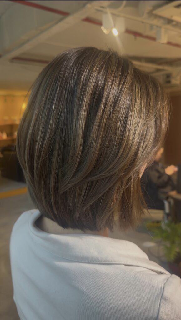 Beige highlight blend with soft layers and natural dimension by Senior Stylist Sylvia at Colors Japanese Hair Salon Singapore.