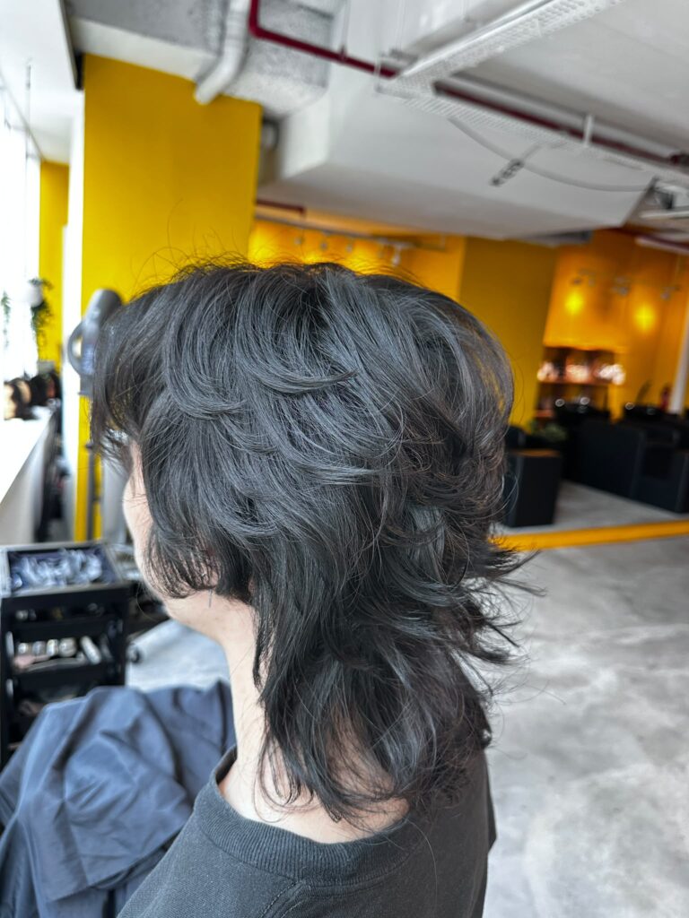 Japanese men’s medium wolf perm at Japanese Hair Salon Singapore. Layered wolf haircut with natural curls, movement, and volume using digital or cold perm techniques