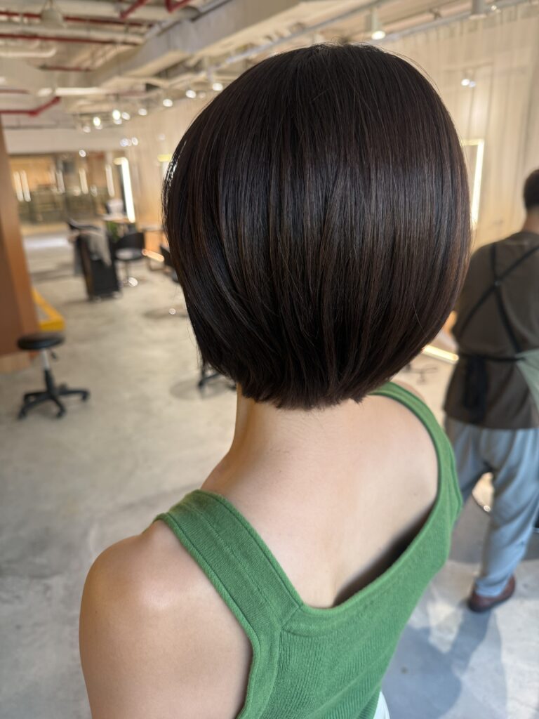 Compact bob haircut with cool brown grey coverage at Japanese Hair Salon Singapore. Bright grey hair color using low-damage Plex Color and BYKARTE treatment for healthy, smooth, naturally rounded hair.