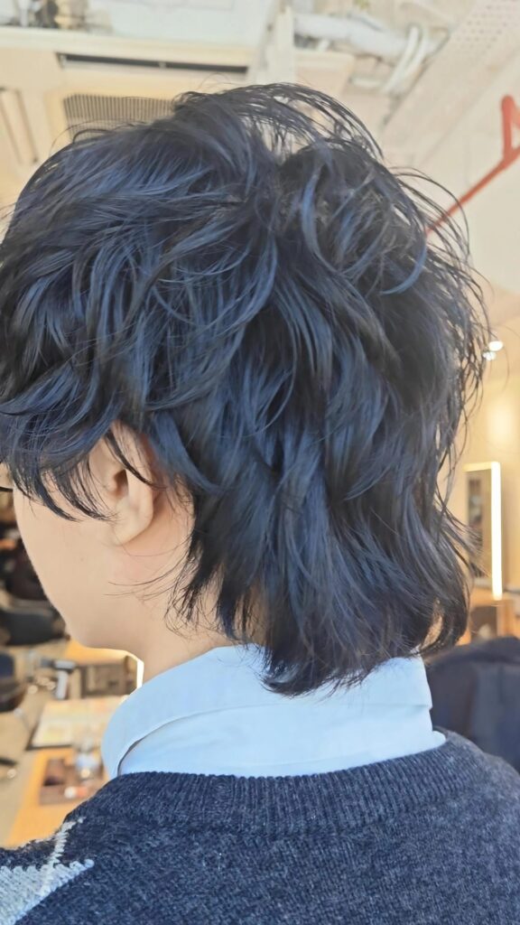 Men’s wolf cut with natural perm on short layered hair, adding movement and volume without color in Singapore