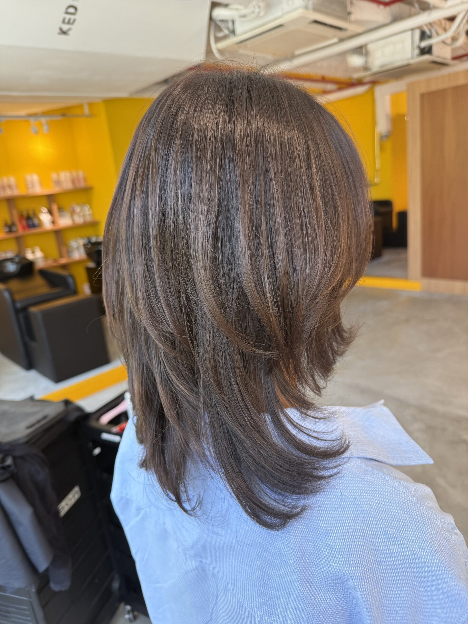 Soft layered medium hairstyle with natural movement, colored by Colorist Ura and cut by Stylist Satsuki at a Japanese hair salon in Singapore