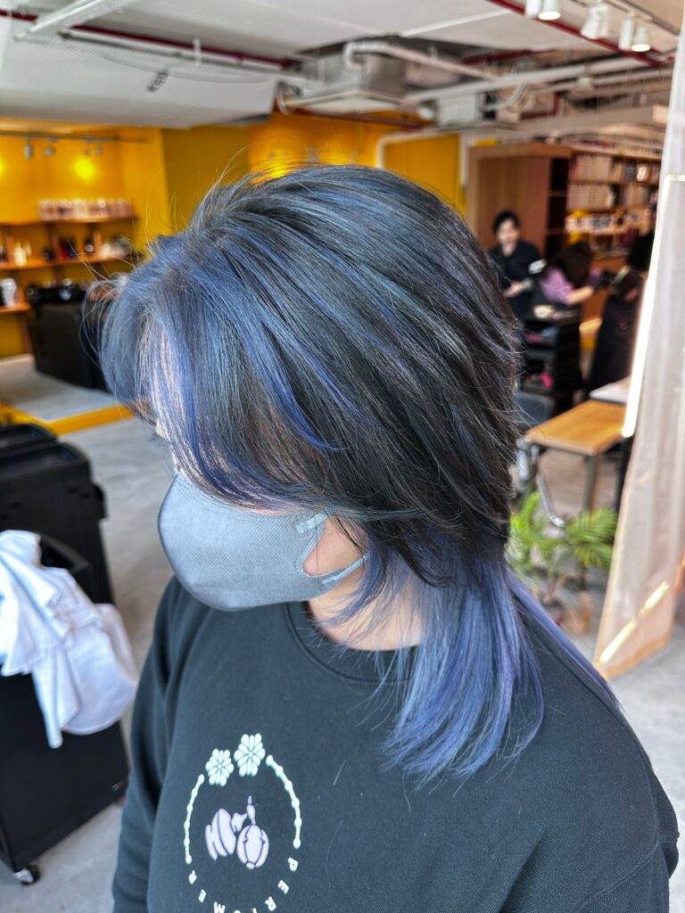 Light blue design color on short wolf layered haircut with dark base by stylist Issey at Colors Japanese Hair Salon Singapore