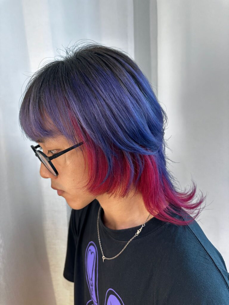 This eye-catching hairstyle combines a bold Wolf Cut with vivid purple and red tones, featuring inner panel coloring for added dimension and contrast. Designed by stylists at our Japanese hair salon in Singapore, it’s perfect for those who want a standout, creative look. Ideal for fashion-forward clients near Clarke Quay, Robertson Quay, and Chinatown.