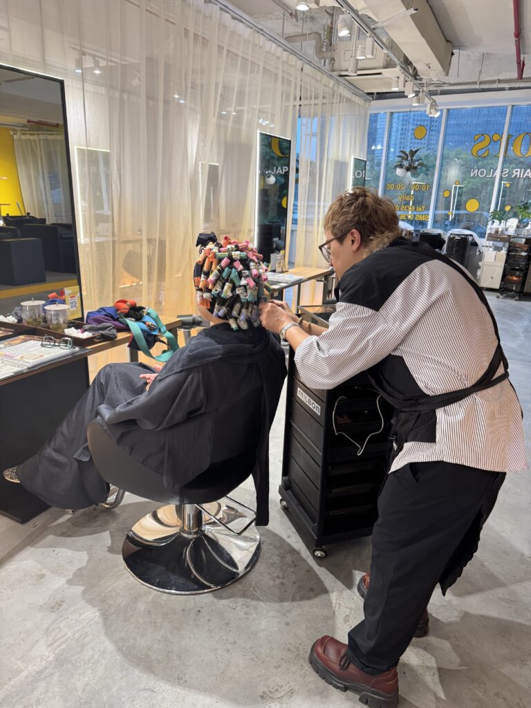 Professional volume and spiral perm technique at Colors Japanese Hair Salon Singapore near Clarke Quay and Havelock Road, creating natural lift and long-lasting movement.