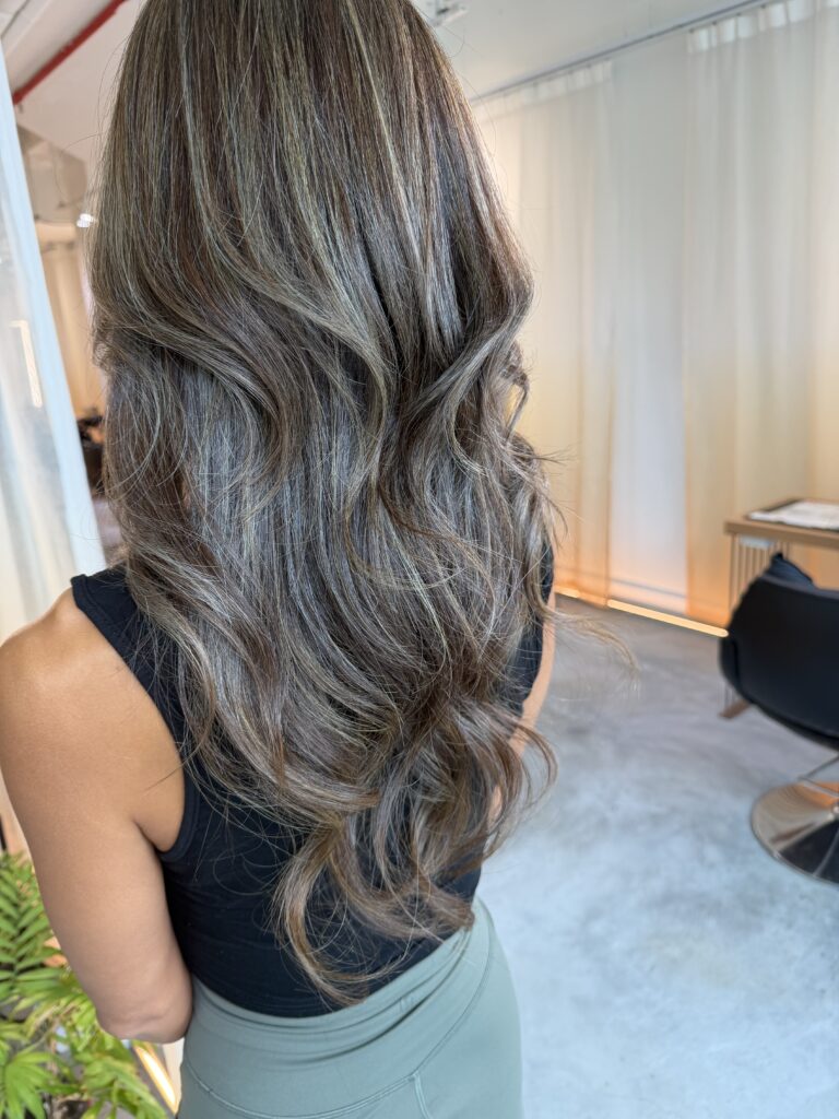 Grey Blending Highlights – Olive Gold Long Layers | Singapore 1 Grey blending highlights in olive gold tone on long layered hair, soft luminous finish, seamless white hair blending, low-maintenance grow-out at Japanese hair salon in Singapore near Clarke Quay MRT and Chinatown.