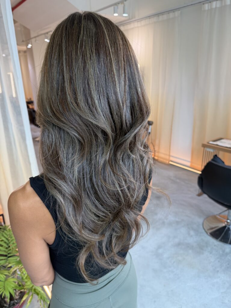 Grey blending olive brown long hair with high layers by Japanese colorist in Singapore