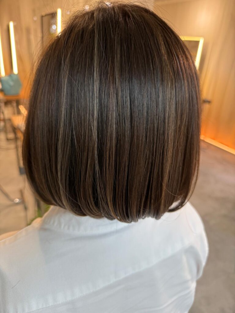 Structured compact bob haircut with natural brown highlights at Colors Japanese Hair Salon Singapore near Clarke Quay MRT, humidity-resistant bob design for Asian hair