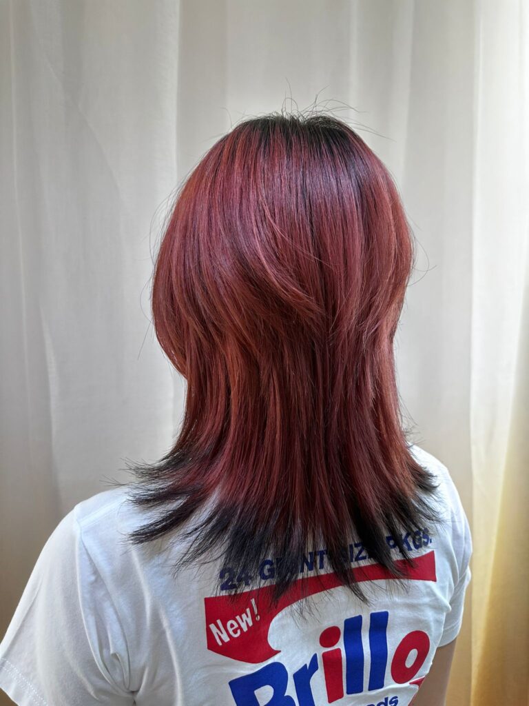 Cherry red medium wolf cut with removable black ends, plex color technique for low damage and treatment effect at a Japanese hair salon in Singapore