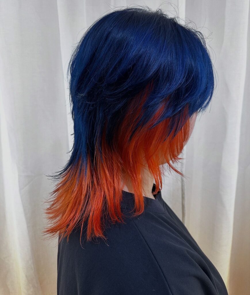 High-saturation blue and orange full bleach color at Colors Japanese Hair Salon Singapore, Japanese hair salon near Clarke Quay, bold contrast design with high-layer haircut and dynamic movement
