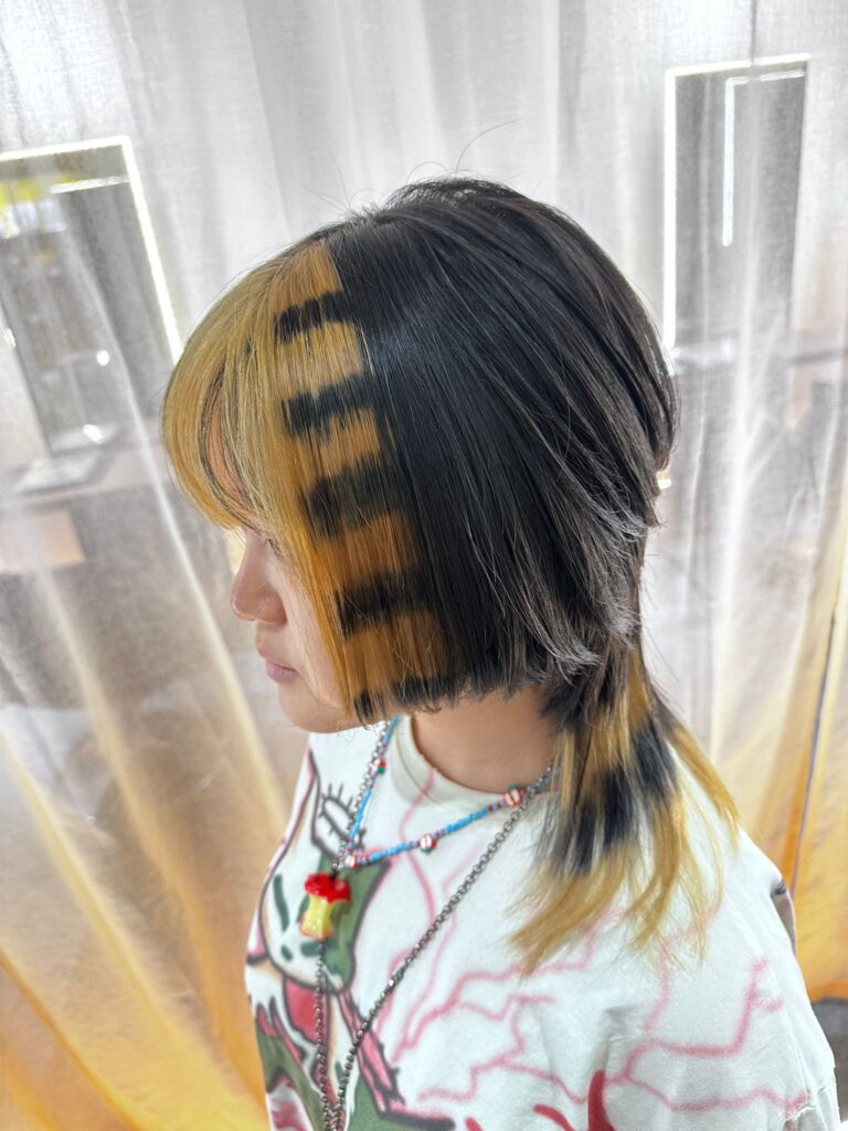 Yellow and black stripe design color with low-damage PLEX bleach at Colors Japanese Hair Salon Singapore, creative contrast color near Clarke Quay