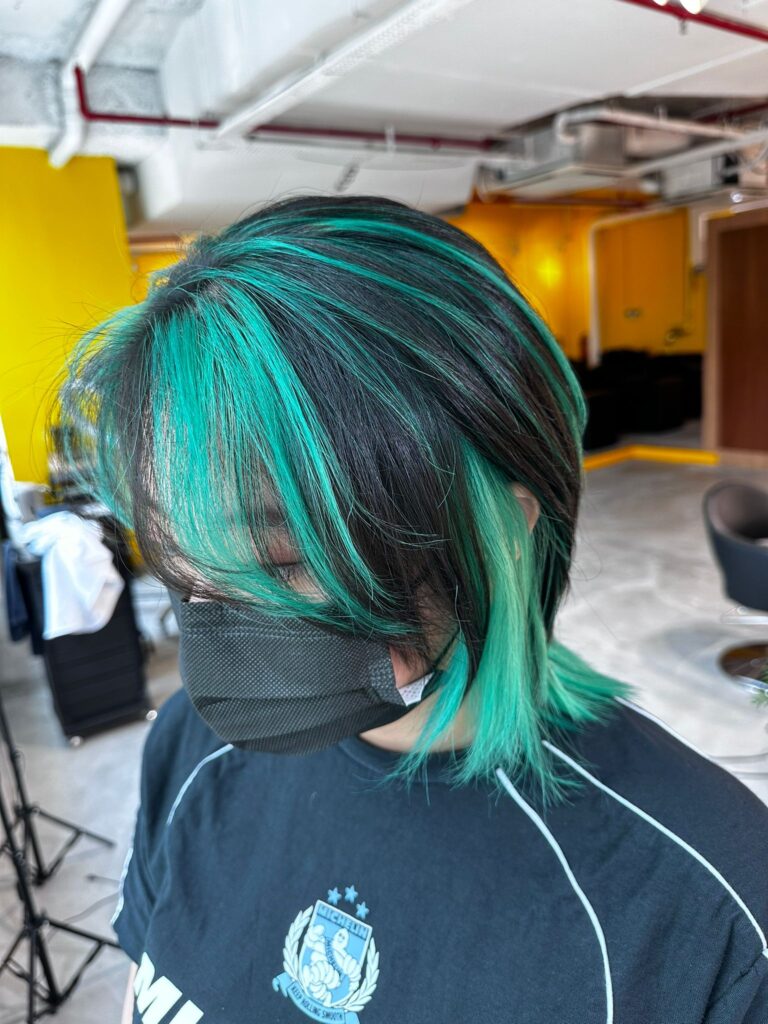 Low-Damage Green Bleach Wolf Cut at Colors Japanese Hair Salon Singapore (Near Clarke Quay) 1 Green accent bleach design layered over a black base with plex technology at Colors Japanese Hair Salon Singapore, low-damage creative color