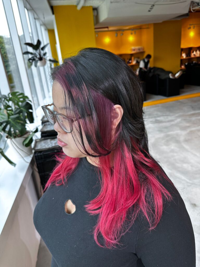 Raccoon inner bleach red and black stripe design with long bangs at Japanese Hair Salon Singapore near Clarke Quay.
