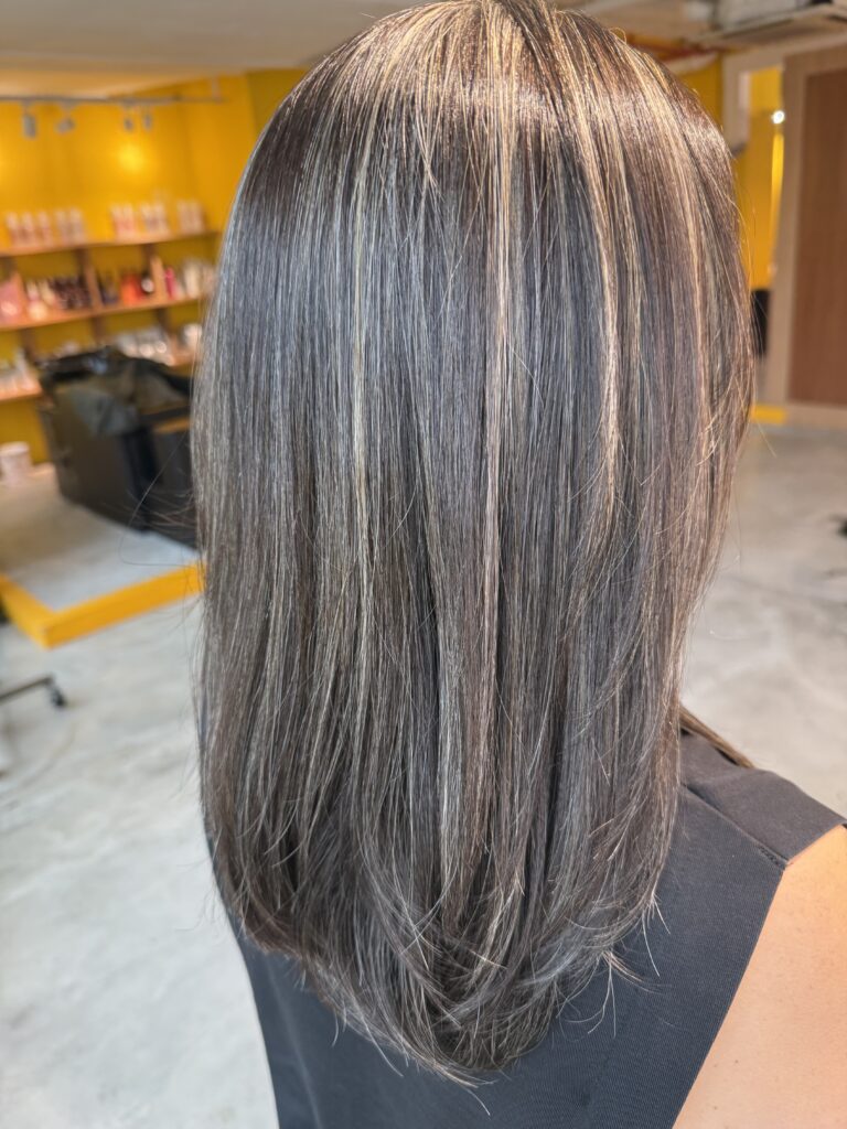 Grey blending hair color with soft low-layer haircut at Colors Japanese Hair Salon Singapore, showing natural regrowth, smooth texture, and low-maintenance grey blending result.