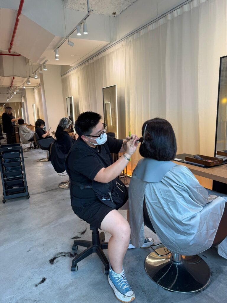 Junior stylist Faye from Malaysia providing haircut hair color perm and relaxing shampoo service at Colors Japanese Hair Salon Singapore near Clarke Quay Chinatown Singapore