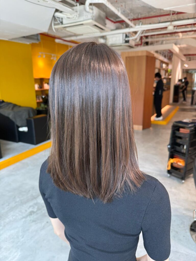 Medium straight haircut with ash color for reducing red tones at Japanese Hair Salon Singapore