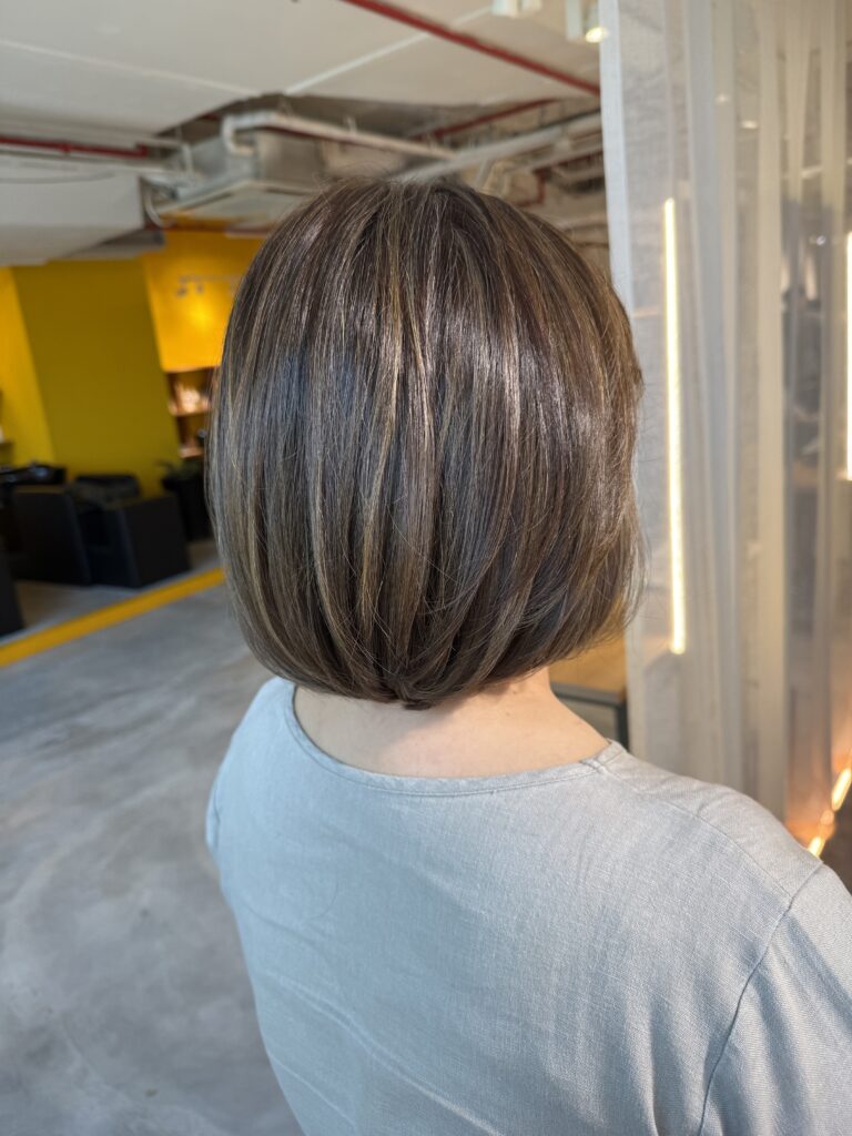 Grey blending beige gold bob hairstyle in Singapore with soft bleach highlights for natural grey hair coverage at a Japanese hair salon.