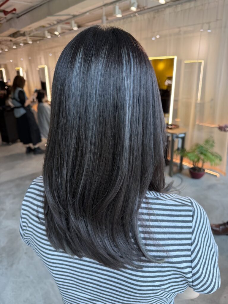Long Low Layers Ash Color Singapore | Japanese Hair Salon 1 Long low-layer haircut with ash color refresh using Plex Color. Existing highlights were preserved without additional bleach, creating soft dimension and smooth, healthy-looking long hair at Colors Japanese Hair Salon Singapore.