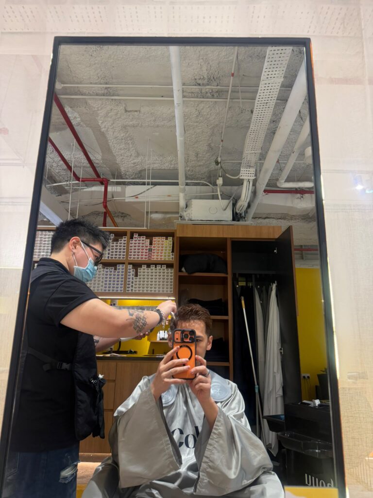 Japanese men's haircut with clean fade and natural styling by Jr. Stylist Faye at Colors Japanese Hair Salon Singapore.