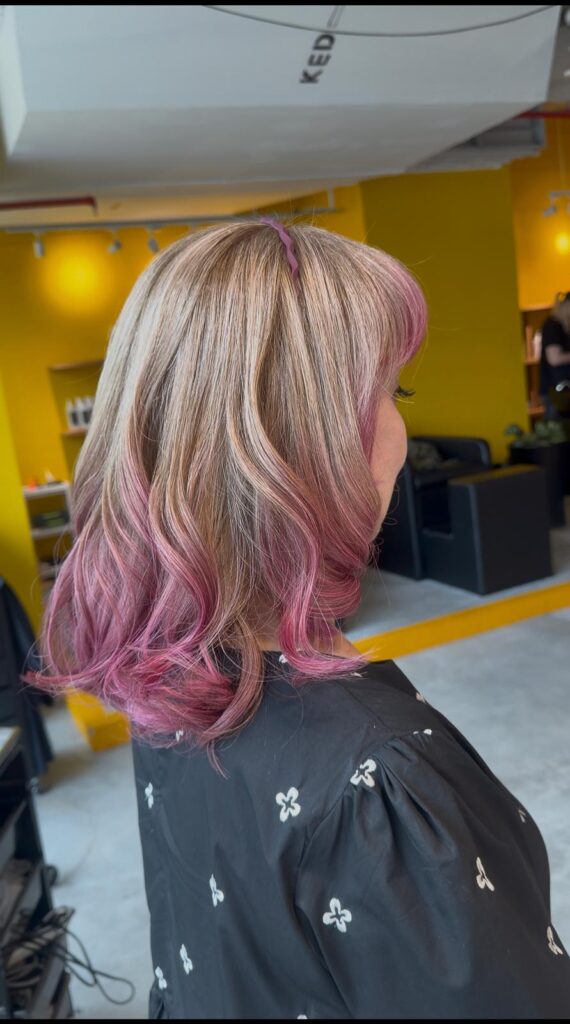 Grey hair blending with vibrant pink design color by Stylist Satsuki and Colorist Ura at Colors Japanese Hair Salon Singapore, featuring face-framing layers and creative fashion color.